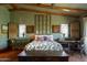 Comfortable bedroom with wooden beamed ceilings, warm decor, and natural light coming through the windows at 27050 N 103Rd St, Scottsdale, AZ 85262