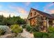 Backyard features stone facade with beautiful window and garden details at 27050 N 103Rd St, Scottsdale, AZ 85262