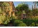 Stone facade with archway leading to gardens provides old world charm at 27050 N 103Rd St, Scottsdale, AZ 85262