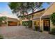 Exterior showcases stone, vine-covered walls, and a brick driveway for curb appeal at 27050 N 103Rd St, Scottsdale, AZ 85262