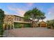 Elegant property showcasing lush landscaping, a brick driveway, and stone exterior accents at 27050 N 103Rd St, Scottsdale, AZ 85262