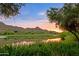 Picturesque golf course view with sunset sky reflecting on the tranquil lake at 27050 N 103Rd St, Scottsdale, AZ 85262