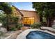 Backyard features a hot tub and stone facade with garden and path at 27050 N 103Rd St, Scottsdale, AZ 85262