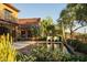 Backyard features a pool with lounge seating and beautiful trees at 27050 N 103Rd St, Scottsdale, AZ 85262