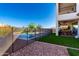 Backyard features an in-ground pool with a fenced-in patio and an outdoor seating area with grill at 30857 N 128Th Dr, Peoria, AZ 85383