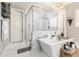 Luxury bathroom featuring frameless shower, soaking tub, designer fixtures and bright lighting at 30857 N 128Th Dr, Peoria, AZ 85383