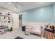 Bright bedroom featuring wainscoting, soft blue accents, and a cozy toddler bed with playful bedding at 30857 N 128Th Dr, Peoria, AZ 85383