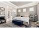 Cozy bedroom with soft rug, queen sized bed, shuttered windows, tray ceiling and light gray color palette at 30857 N 128Th Dr, Peoria, AZ 85383