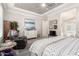 Serene bedroom with plantation shutters, tray ceiling, soft rug, sitting area and access to ensuite bathroom at 30857 N 128Th Dr, Peoria, AZ 85383