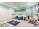 Charming bedroom with blue walls, a playful starfish rug, and a cozy reading nook at 30857 N 128Th Dr, Peoria, AZ 85383