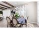 Bright dining room with wood beams, blue tablecloth, and curtains at 30857 N 128Th Dr, Peoria, AZ 85383