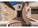 Welcoming front entrance with a stone wall, brick walkway, and stylish exterior lighting at 30857 N 128Th Dr, Peoria, AZ 85383
