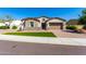 Charming single-story home featuring stone accents, a two-car garage, and a well-manicured lawn at 30857 N 128Th Dr, Peoria, AZ 85383