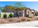 Attractive two-story home with desert landscaping, manicured bushes, and an inviting, cozy feel at 30857 N 128Th Dr, Peoria, AZ 85383