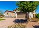 Charming single-story home with stone accents, brick driveway, and attached two-car garage at 30857 N 128Th Dr, Peoria, AZ 85383