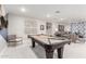 Spacious recreational room featuring a pool table and inviting living space, perfect for entertaining guests at 30857 N 128Th Dr, Peoria, AZ 85383