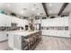 Bright, open kitchen features a large island, white cabinets, and stainless steel appliances at 30857 N 128Th Dr, Peoria, AZ 85383