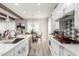 Bright, modern kitchen with white cabinets, stainless steel appliances, marble counters and adjacent dining area at 30857 N 128Th Dr, Peoria, AZ 85383