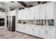 Bright kitchen with white cabinets, stainless steel fridge, and a decorative backsplash at 30857 N 128Th Dr, Peoria, AZ 85383