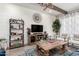 Cozy living room with shiplap wall, TV, decorative shelves, and a rustic coffee table at 30857 N 128Th Dr, Peoria, AZ 85383