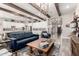 Open-concept living room with a blue sofa, island seating, and a view into the foyer at 30857 N 128Th Dr, Peoria, AZ 85383