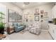 Inviting living room with soft seating, shuttered windows, gallery wall and neutral color palette at 30857 N 128Th Dr, Peoria, AZ 85383