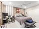 Stylish bedroom with a brick accent wall, modern decor, and a comfortable bed, creating a cozy retreat at 30857 N 128Th Dr, Peoria, AZ 85383