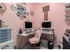 Charming pink office with trendy décor, dual monitor setup, ample storage and comfortable seating at 30857 N 128Th Dr, Peoria, AZ 85383