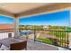 Covered patio overlooking a beautiful backyard with a pool, artificial grass, and scenic mountain views at 30857 N 128Th Dr, Peoria, AZ 85383