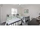 Shared bedroom features two twin beds, a ceiling fan, and neutral-colored walls at 325 W San Angelo St, Gilbert, AZ 85233