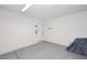An attached garage featuring painted walls, a simple lighting fixture, and an access door at 325 W San Angelo St, Gilbert, AZ 85233