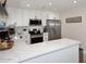 Bright, renovated kitchen with stainless steel appliances, white cabinets, and marble countertops at 325 W San Angelo St, Gilbert, AZ 85233