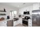 Updated kitchen features stainless steel appliances, bright white cabinets, and a view to the backyard at 325 W San Angelo St, Gilbert, AZ 85233