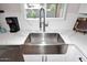 Modern kitchen sink with stainless steel faucet and white marble countertops near a bright window at 325 W San Angelo St, Gilbert, AZ 85233