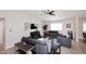 Spacious living room with modern furniture, stylish decor, and wood-look flooring under a ceiling fan at 325 W San Angelo St, Gilbert, AZ 85233