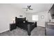 Spacious main bedroom with a ceiling fan, window, and dark-colored furniture at 325 W San Angelo St, Gilbert, AZ 85233