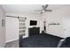 Bright main bedroom featuring a sliding barn door, dresser, ceiling fan, and modern decor at 325 W San Angelo St, Gilbert, AZ 85233
