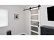 Main bedroom with frosted glass barn door, grey dresser and modern decor at 325 W San Angelo St, Gilbert, AZ 85233
