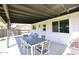 Relax on the back patio featuring a dining table and seating area, ideal for outdoor dining at 325 W San Angelo St, Gilbert, AZ 85233