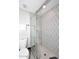Modern bathroom with a glass enclosed shower featuring decorative tiling and neutral colors at 325 W San Angelo St, Gilbert, AZ 85233