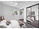 Bedroom showcasing mirrored closet doors, a ceiling fan, and a window with beautiful natural light at 332 E Houston Ave, Gilbert, AZ 85234
