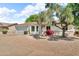 Single-story home with desert landscaping, mature trees, and an attached two car garage at 332 E Houston Ave, Gilbert, AZ 85234