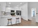 Modern kitchen features white cabinets, stainless steel appliances, and a breakfast bar with stylish barstools at 332 E Houston Ave, Gilbert, AZ 85234