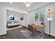 Bright living room transformed into a versatile space with a desk and a bed at 332 E Houston Ave, Gilbert, AZ 85234