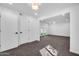Bright living room with plush carpeting, white walls, and doors leading outside at 332 E Houston Ave, Gilbert, AZ 85234