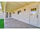 Covered patio featuring painted support beams and a door that leads to interior at 332 E Houston Ave, Gilbert, AZ 85234