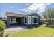 Charming home with a well-kept lawn, trimmed bushes, and a cozy patio at 3386 E Strawberry Dr, Gilbert, AZ 85298