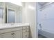 Well-maintained bathroom with a modern vanity, mirror, and a bathtub with shower at 3386 E Strawberry Dr, Gilbert, AZ 85298