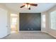 Cozy bedroom features plush carpeting and a custom accent wall at 3386 E Strawberry Dr, Gilbert, AZ 85298