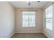 Neutral bedroom features carpet, a ceiling fan, and bright windows for natural light at 3386 E Strawberry Dr, Gilbert, AZ 85298
